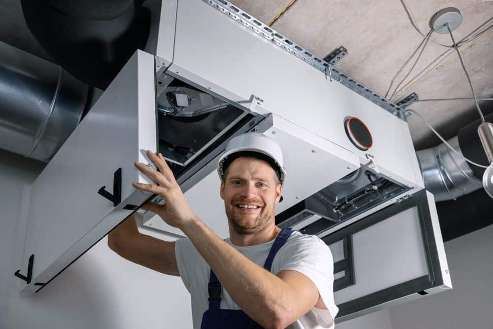 HVAC technician working on heating system in New Jersey