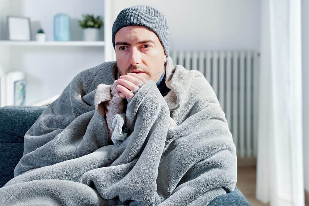 Man cold because of broken furnace in New Jersey and in need of New Jersey HVAC professional to come repair this issue